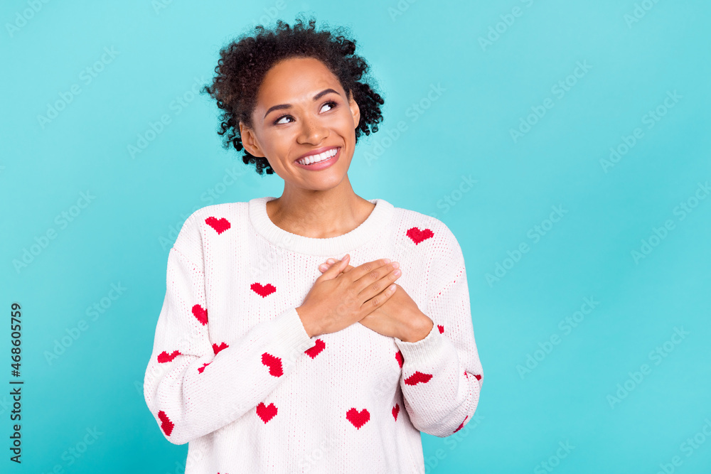 Photo of sweet adorable african lady dressed white sweater arms chest looking empty space smiling isolated blue color background Photo of sweet adorable african lady dressed white sweater arms chest looking empty space smiling isolated blue color background