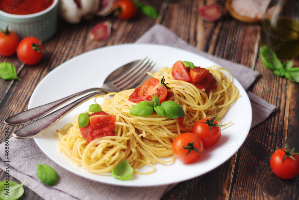 Italian pasta spaghetti with basil and cherry tomatoes Italian pasta spaghetti with basil and cherry tomatoes
