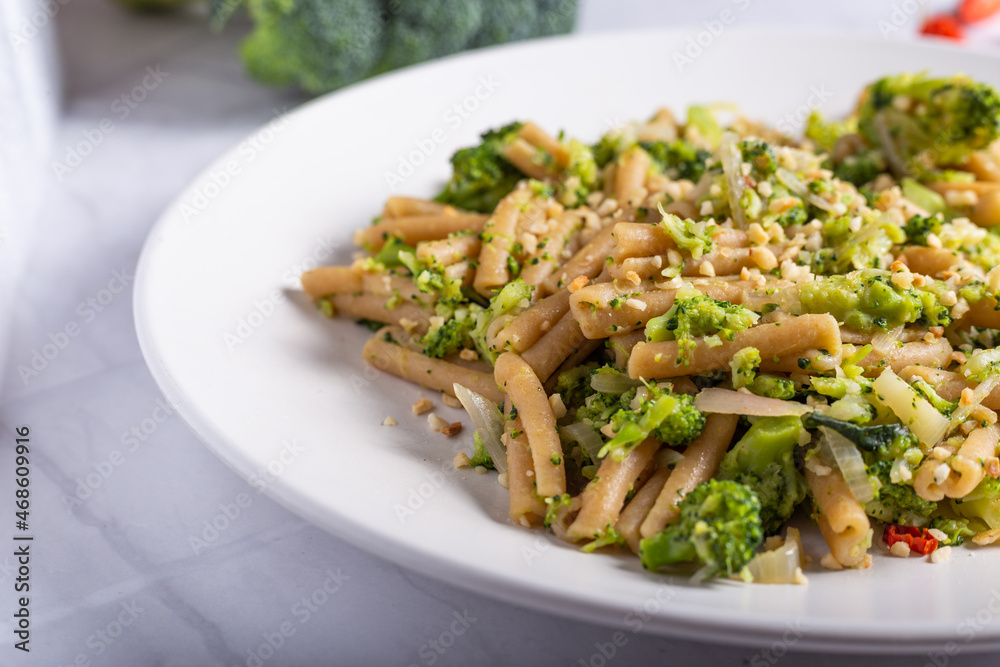 Vegan wholemeal pasta with broccoli and chopped hazelnuts Vegan wholemeal pasta with broccoli and chopped hazelnuts