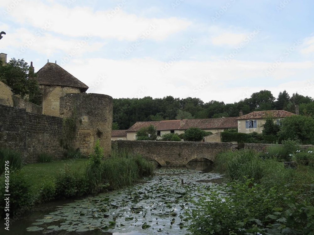 Tower and moat around Benedictine abbey of Saint Junien in Nouaille Maupertuis France