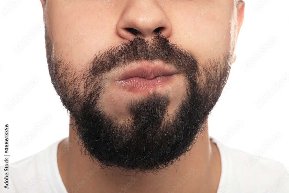 Man rinsing his mouth on white background, closeup. Dental care