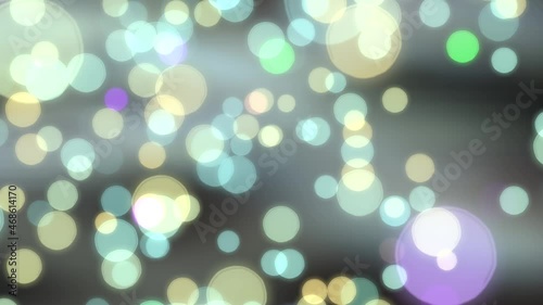 Glowing colored bokeh background with floating light particles