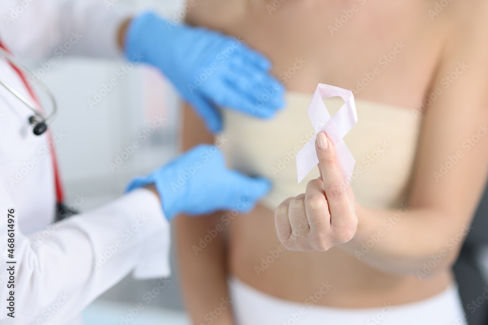 Gynecologist conducts medical examination of female breast Gynecologist conducts medical examination of female breast