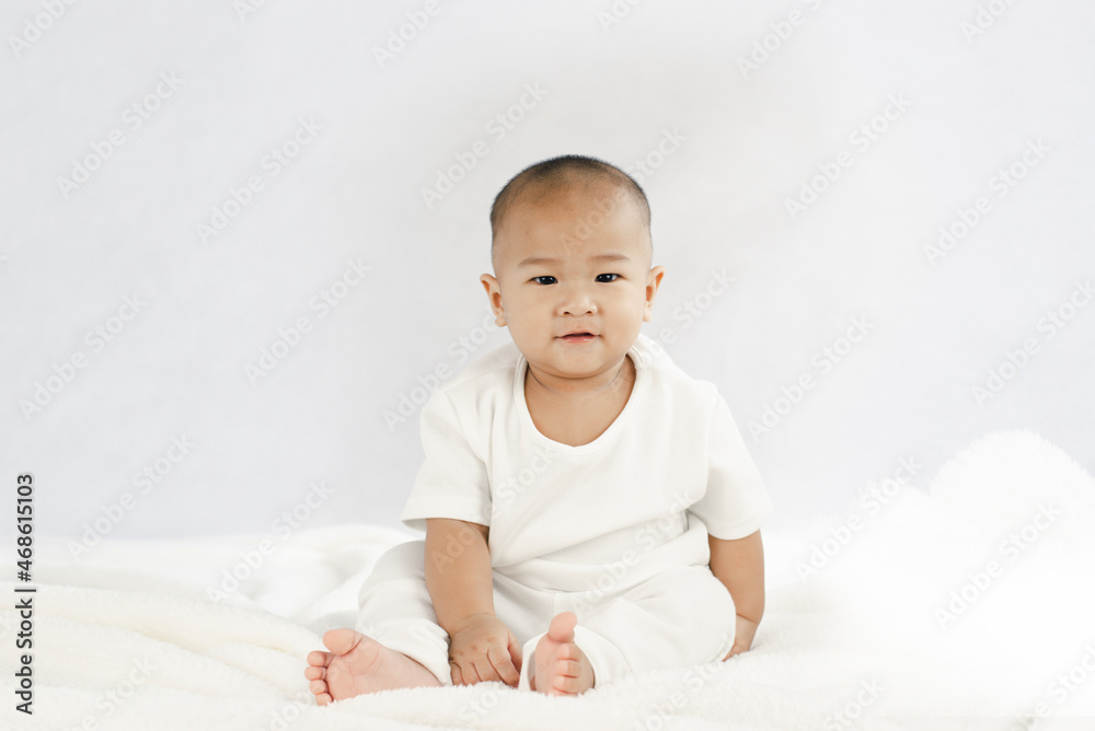 Charming 9 month old baby in white clothes on the bed
Charming 9 month old baby in white clothes on the bed