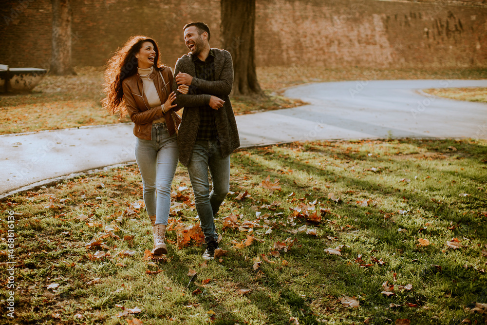 Fototapeta premium Young couple walking in autumn park