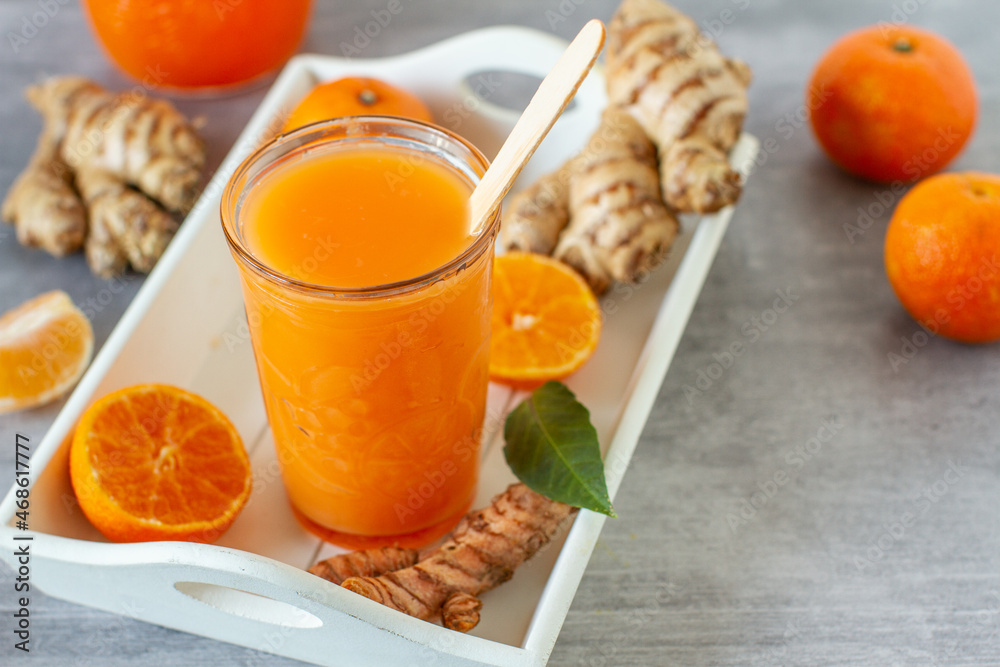 Winter smoothie with ginger, turmeric and  tangerine  - obrazy, fototapety, plakaty 