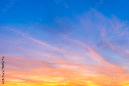 Fototapeta Naklejka Na Ścianę i Meble -  Twilight blue bright and orange yellow dramatic sunset sky in countryside or beach colorful cloudscape texture with white clouds air background.