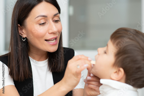 Cute preschool child is engaged in speech therapist office and correcting his speech