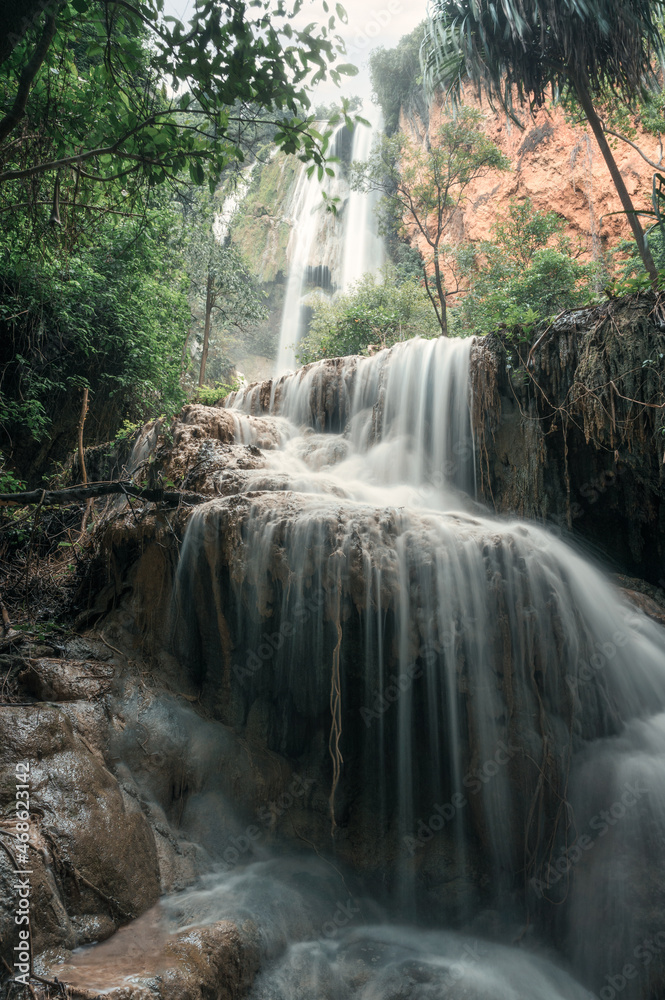 Fototapeta premium Erawan waterfall 7th floor with water flowing in tropical rainforest at national park