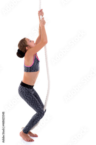 Smiling girl hanging on rope