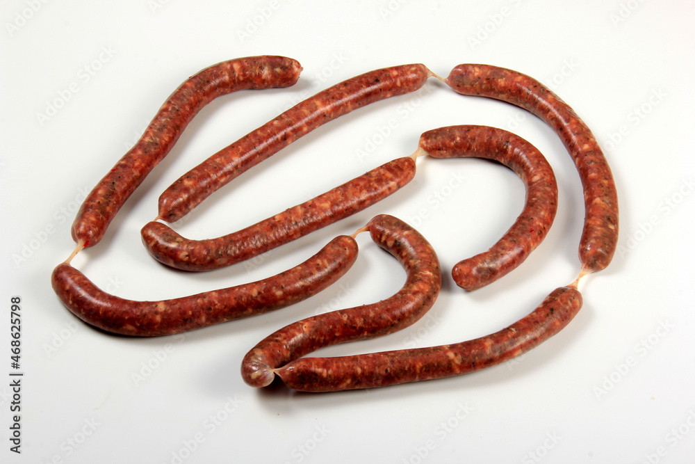 Raw sausage with basil leaf isolated on white background. Raw sausage with basil leaf isolated on white background.