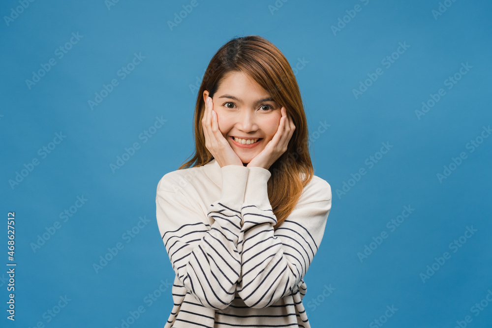 Young Asia lady with positive expression, smile broadly, dressed in casual cloth and look at camera isolated on blue background. Happy adorable glad woman rejoices success. Facial expression concept. Young Asia lady with positive expression, smile broadly, dressed in casual cloth and look at camera isolated on blue background. Happy adorable glad woman rejoices success. Facial expression concept.