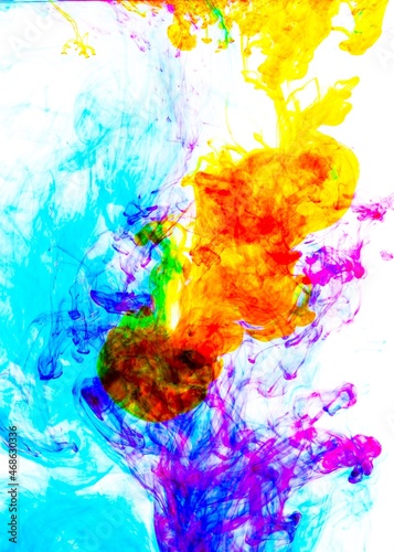 Color drop in water, photographed in motion. Ink swirling in water. Cloud of ink in water . Colorful ink in water, ink drop.