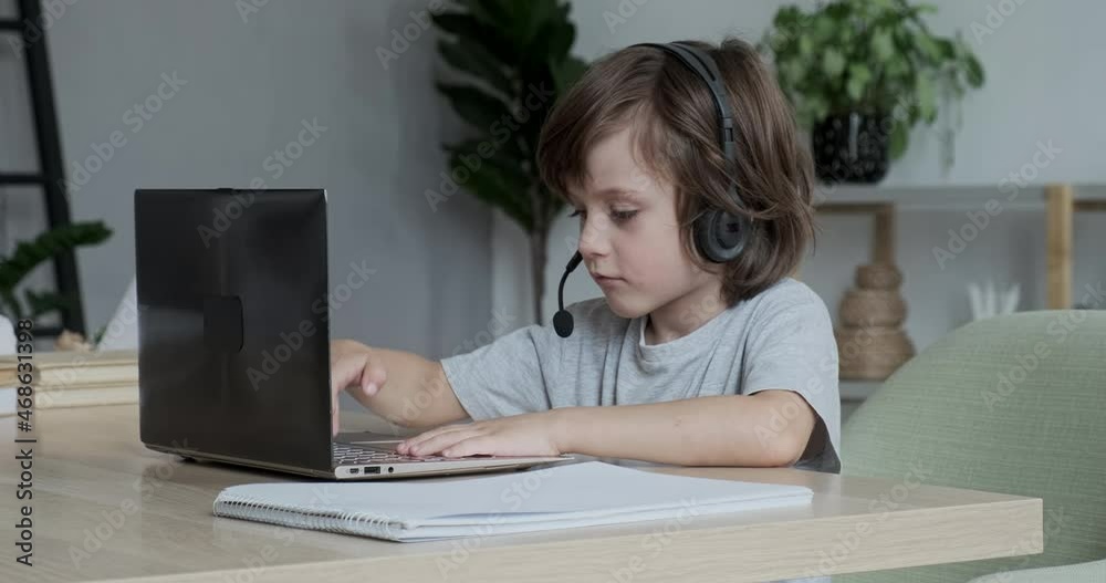 Exhausted, frustrated little boy pupil got tired of working and studying at the computer and closed his laptop in disappointment. Difficulties and stress with online distance education Exhausted, frustrated little boy pupil got tired of working and studying at the computer and closed his laptop in disappointment. Difficulties and stress with online distance education