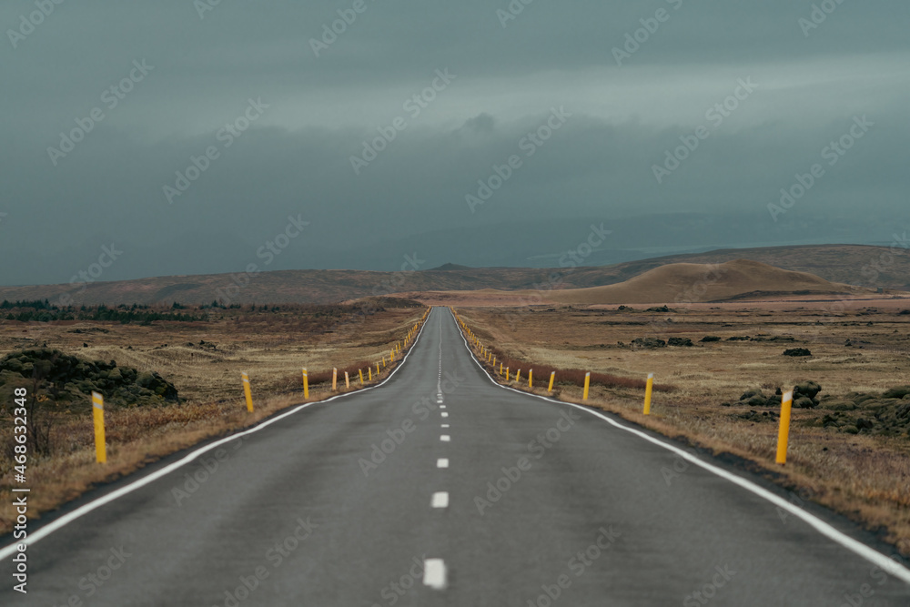 Empty straight road under the clouds for text space