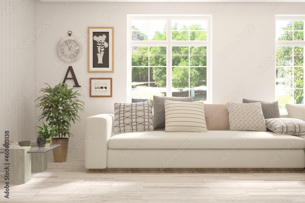 Fototapeta premium White living room with sofa and summer landscape in window. Scandinavian interior design. 3D illustration
