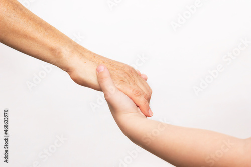 A small caucasian child holds a adult woman by the hand isolated on a white background. Agreement, arrangement, friendship, family. Different generations