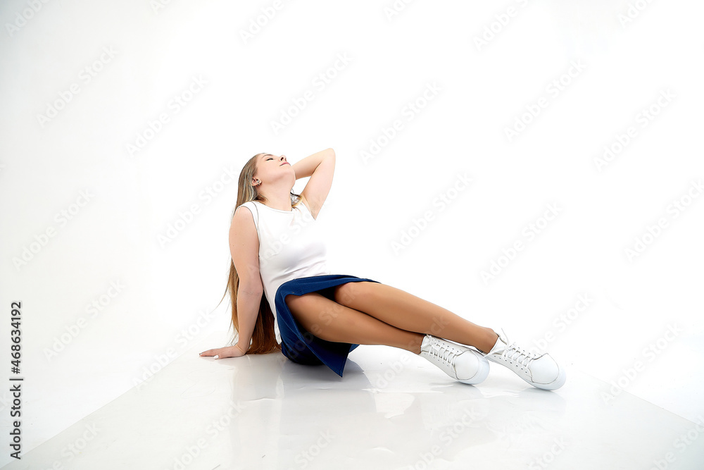 Beautiful young woman or girl wearing casual clothes on white background. Young female model posing during photo shoot