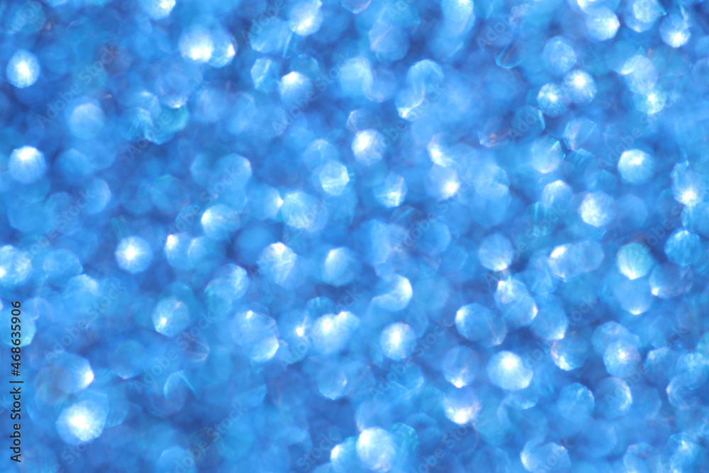 Blue sparkle blurry background with blurred and shiny dots texture