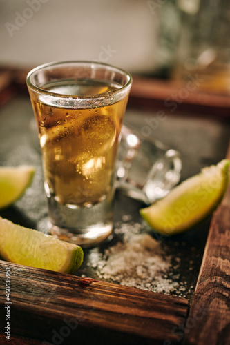 Shots of tequila with slices of lime and salt