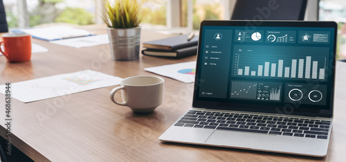 Business data dashboard analysis by ingenious computer software . Investment application display business sales and profit on the computer screen and advise marketing planning decision . photo