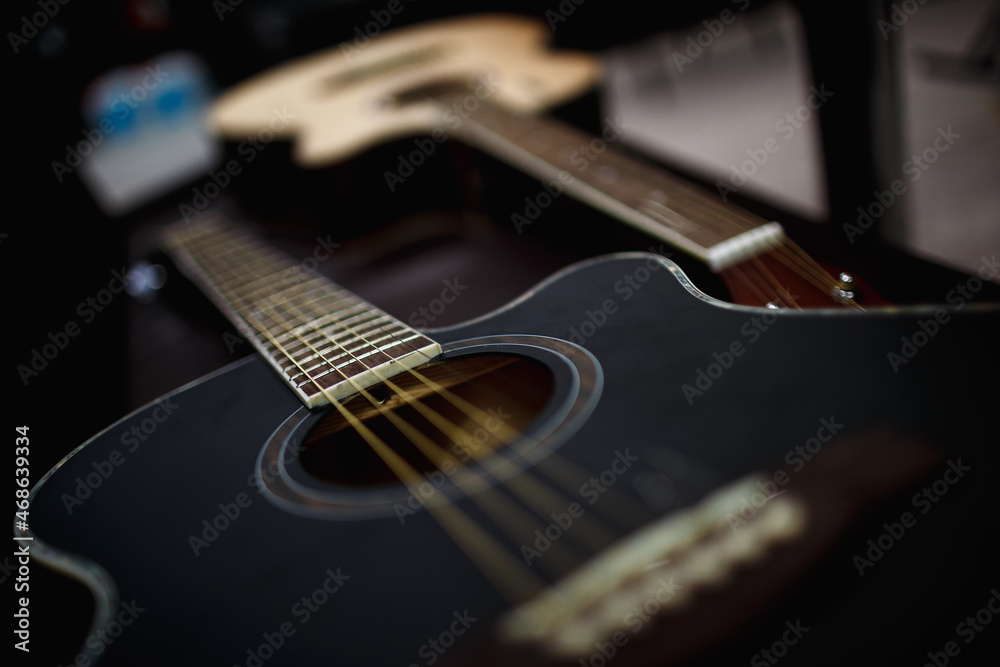 Fototapeta premium two acoustic guitars on a black background