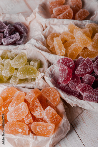 Dessert marmalade in the form of lemon and orange slices. The sweetness of jelly candy. photo