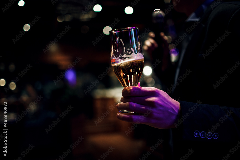 Closeup of a man holding on to his glass