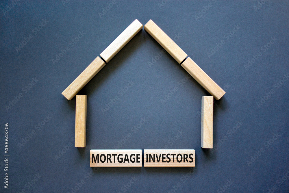 Mortgage investors symbol. Concept words 'Mortgage investors' on wooden blocks near miniature wooden house. Beautiful grey background. Business, mortgage investors concept.