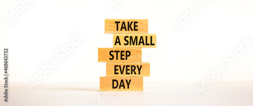 Take a small step every day symbol. Wooden blocks with words Take a small step every day. Beautiful white background, copy space. Business, step every day concept.