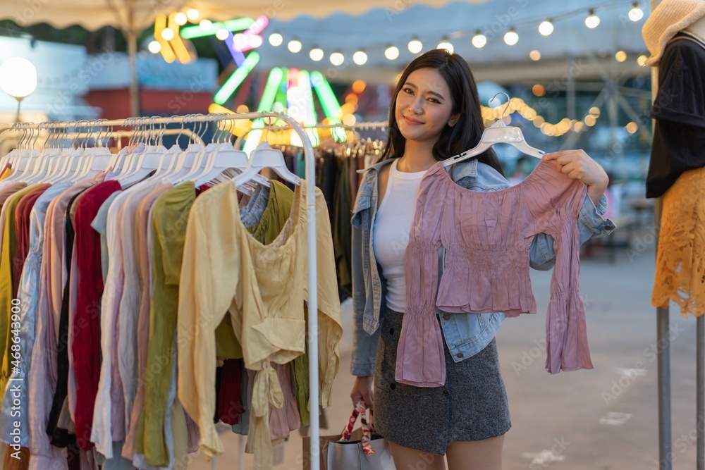 Asian woman shopping in a random night market in Bangkok, Thailand

