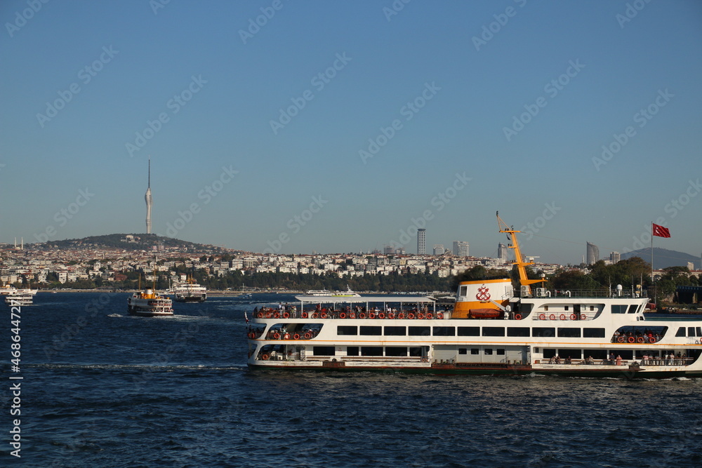 selective focus, 03.08.2021 turkey istanbul: view of newly built tv tower in istanbul's high Çamlıca district with tourist ships from Galata bridge
