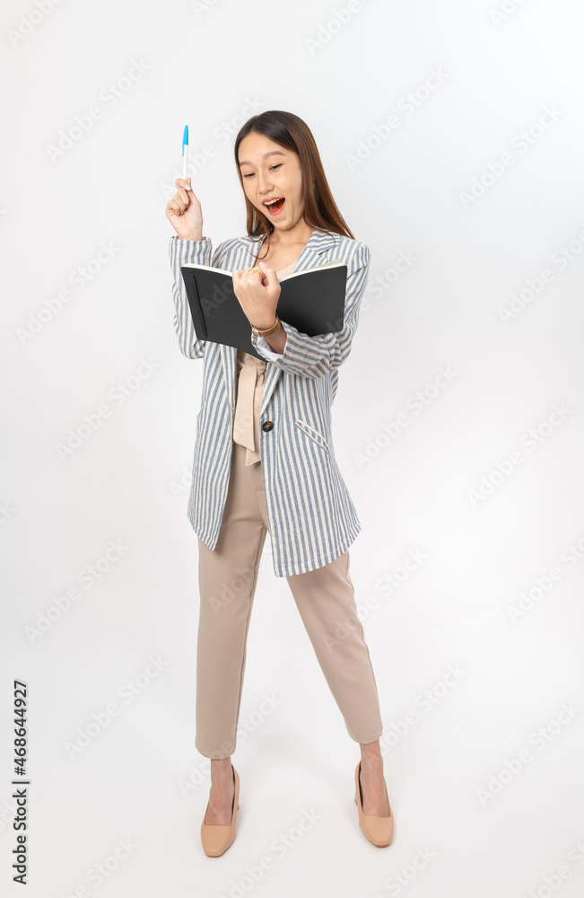 Young asian businesswoman holding a notebook and pen looking for ideas Young asian businesswoman holding a notebook and pen looking for ideas