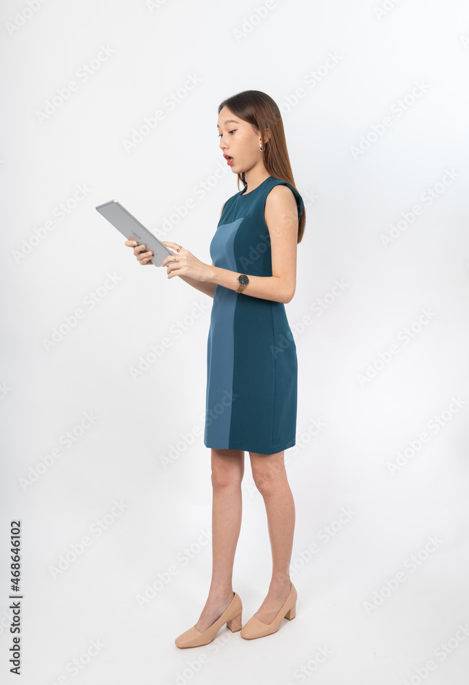 Photograph of a young, beautiful and sexy asian Thai lady model in professional business attire with a tablet on hand Photograph of a young, beautiful and sexy asian Thai lady model in professional business attire with a tablet on hand