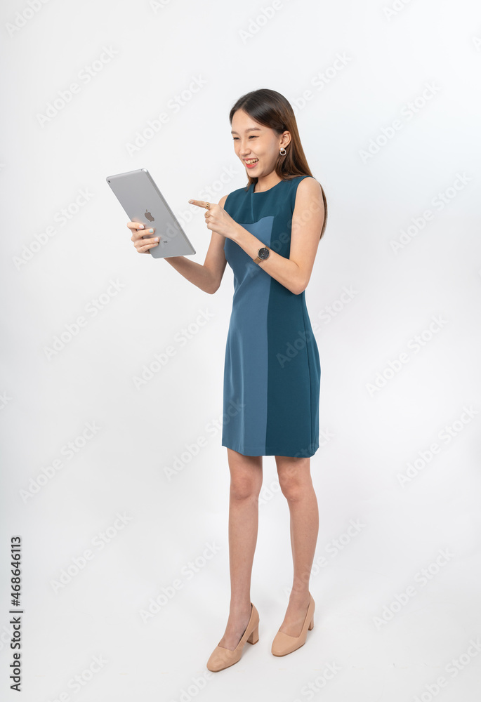 Photograph of a young, beautiful and sexy asian Thai lady model in professional business attire with a tablet on hand Photograph of a young, beautiful and sexy asian Thai lady model in professional business attire with a tablet on hand