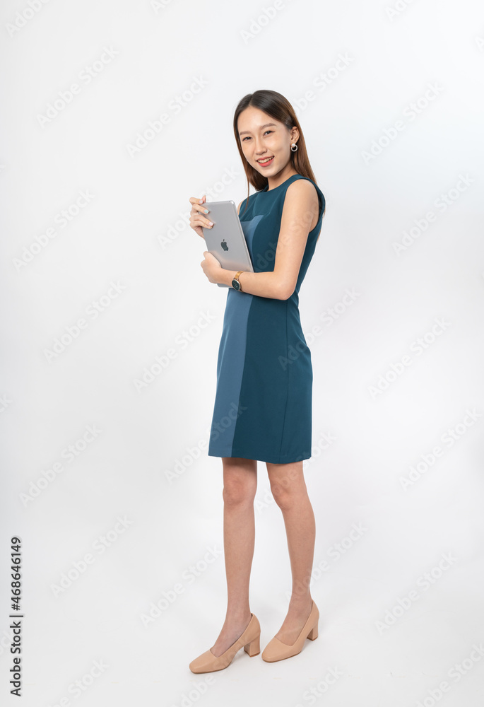 Photograph of a young, beautiful and sexy asian Thai lady model in professional business attire with a tablet on hand Photograph of a young, beautiful and sexy asian Thai lady model in professional business attire with a tablet on hand