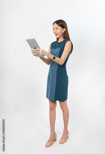 Photograph of a young, beautiful and sexy asian Thai lady model in professional business attire with a tablet on hand