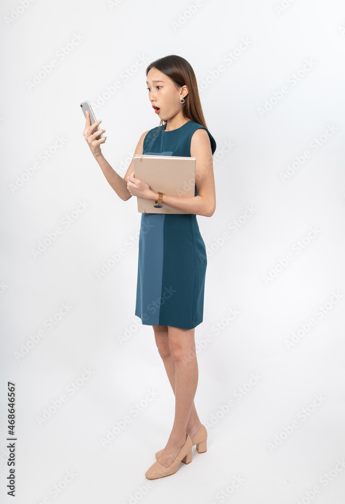 Photograph of a young, beautiful and sexy asian Thai lady model in professional business attire with a mobile phone and notebook on hand Photograph of a young, beautiful and sexy asian Thai lady model in professional business attire with a mobile phone and notebook on hand