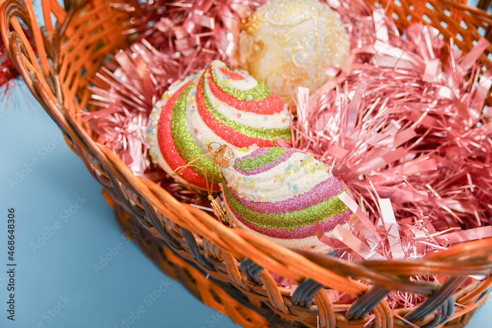 New Year's toys in a wicker basket for decorating a Christmas tree.