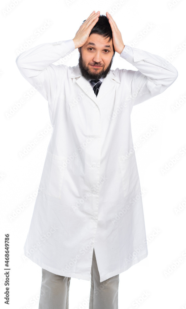 A bearded doctor in a white coat, in a medical uniform clutched his head, frightened, made a mistake. isolated. White background A bearded doctor in a white coat, in a medical uniform clutched his head, frightened, made a mistake. isolated. White background