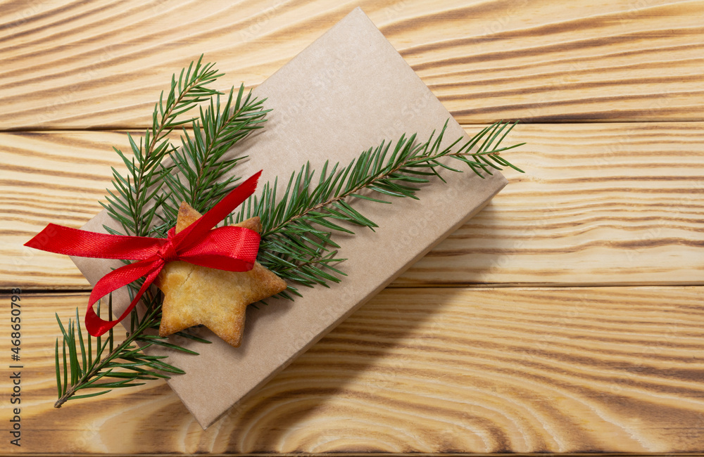 natural paper gift box , gingerbread cookie and fir tree branche on vintage rustic wooden background. Christmas background. New Year theme. Merry Christmas and Happy New Year Holidays greeting card natural paper gift box , gingerbread cookie and fir tree branche on vintage rustic wooden background. Christmas background. New Year theme. Merry Christmas and Happy New Year Holidays greeting card