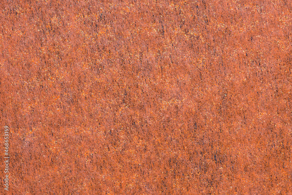 A sheet of orange decorative interlining fabric with golden glitter as a background A sheet of orange decorative interlining fabric with golden glitter as a background