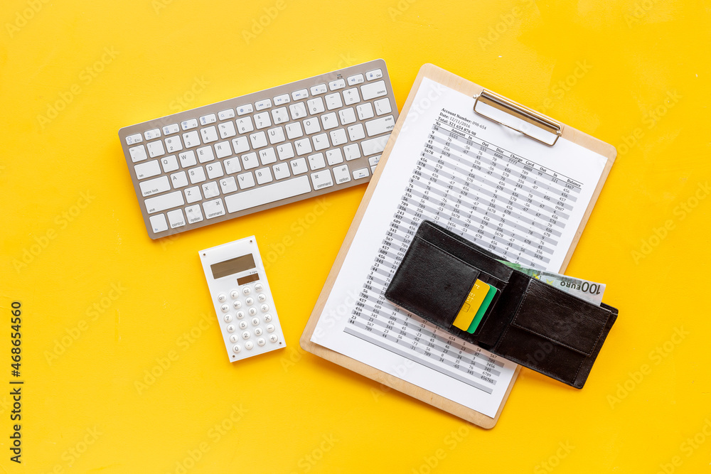 Calculating bills or taxes reports with with purse and bank cards, top view Calculating bills or taxes reports with with purse and bank cards, top view