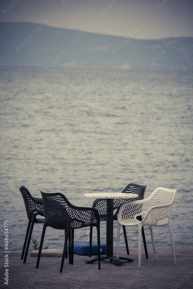 Empty chairs and tables at an open air terrace