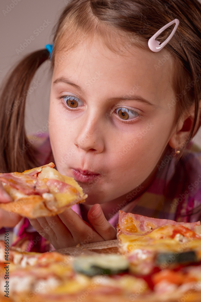 Funny portrait of young beautiful attractive girl eat street food pizza. Selective focus on eyes. Vertical image. Funny portrait of young beautiful attractive girl eat street food pizza. Selective focus on eyes. Vertical image.