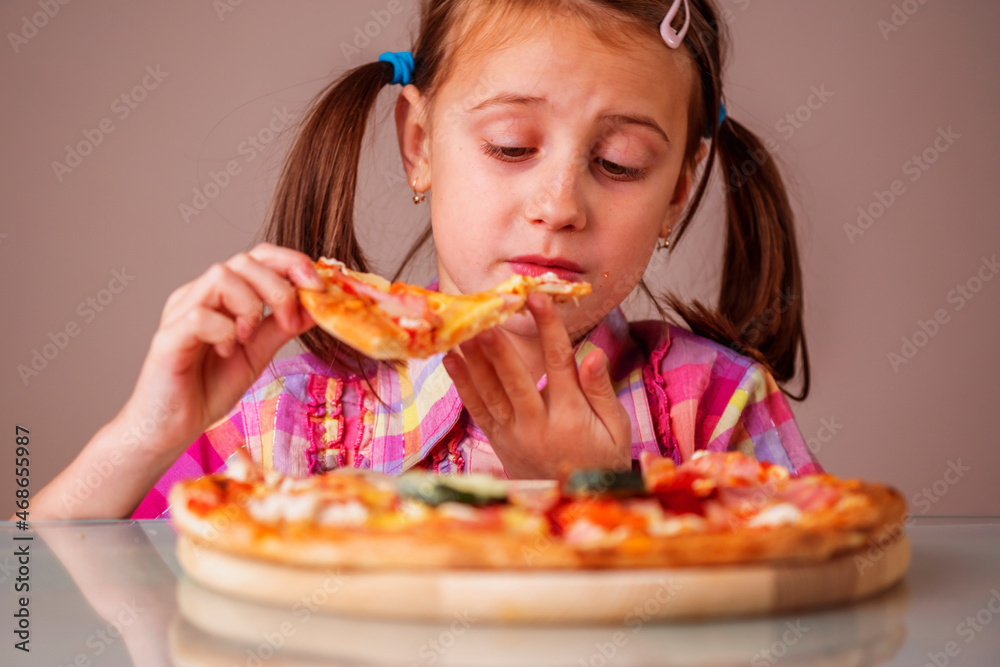 Close up portrait of young beautiful girl enjoys delicious slice of pizza. Horizontal image. Close up portrait of young beautiful girl enjoys delicious slice of pizza. Horizontal image.