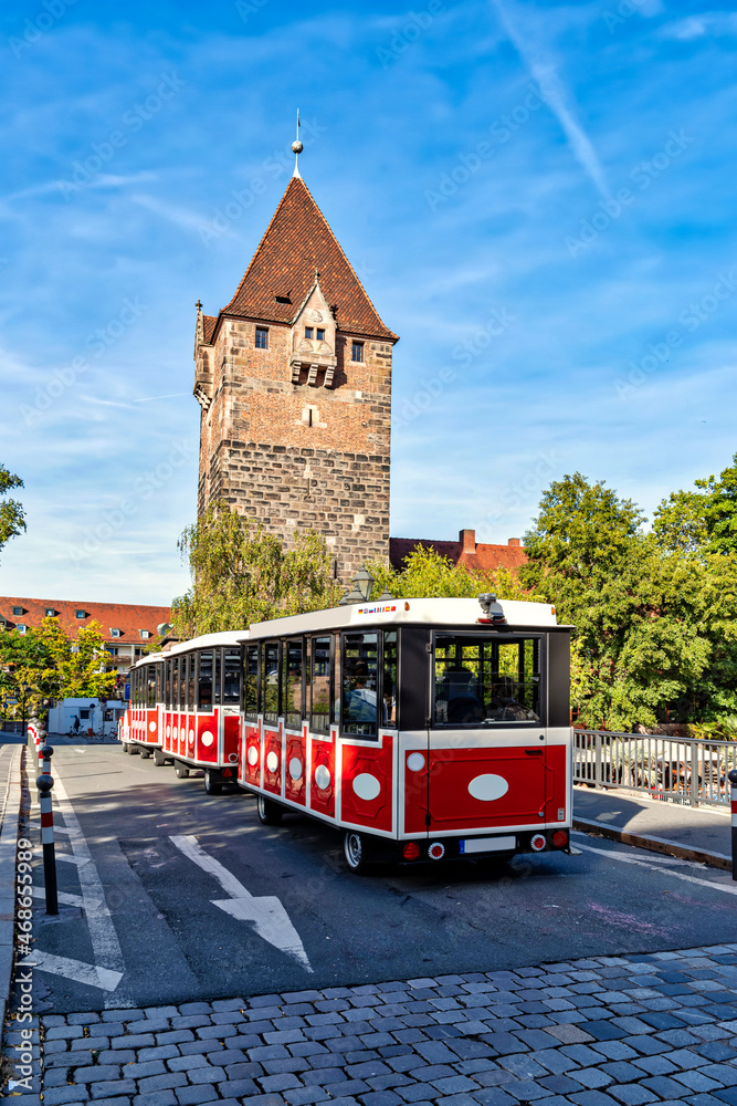 Schuldturm tower with city train on the bridge in Nuremberg, Germany