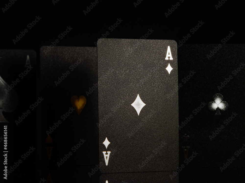 Obraz premium Casino, online casino background. Black poker cards with white and gold stamping on a black background. Gambling, poker, gambling business, game strategy, risk, cash flows.