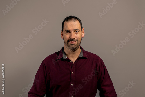 Portrait of proud mid man isolated on grey background