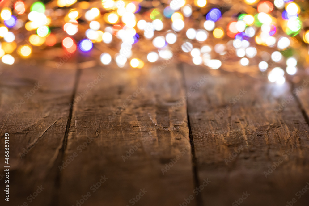 wooden background with glowing electric garland wooden background with glowing electric garland